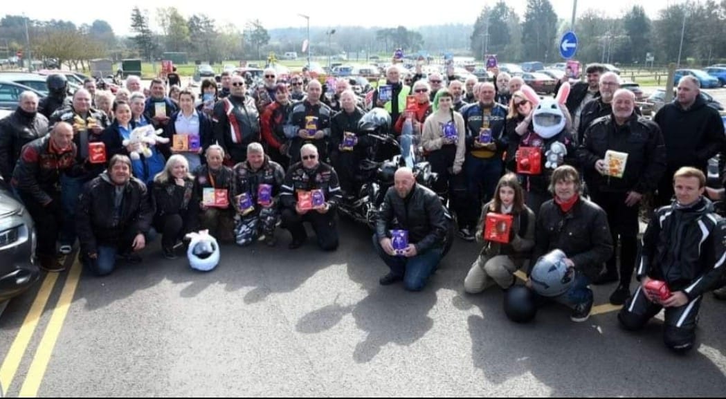A picture of the Freewheel Cruiser Rider’s Association wearing Easter outfits by their bikes, holding up Easter eggs