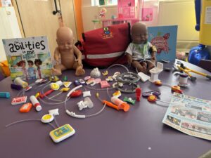 A collection of medical 3-d toys, books and baby dolls