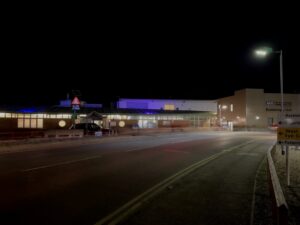 A photo of the QEH lit up in purple